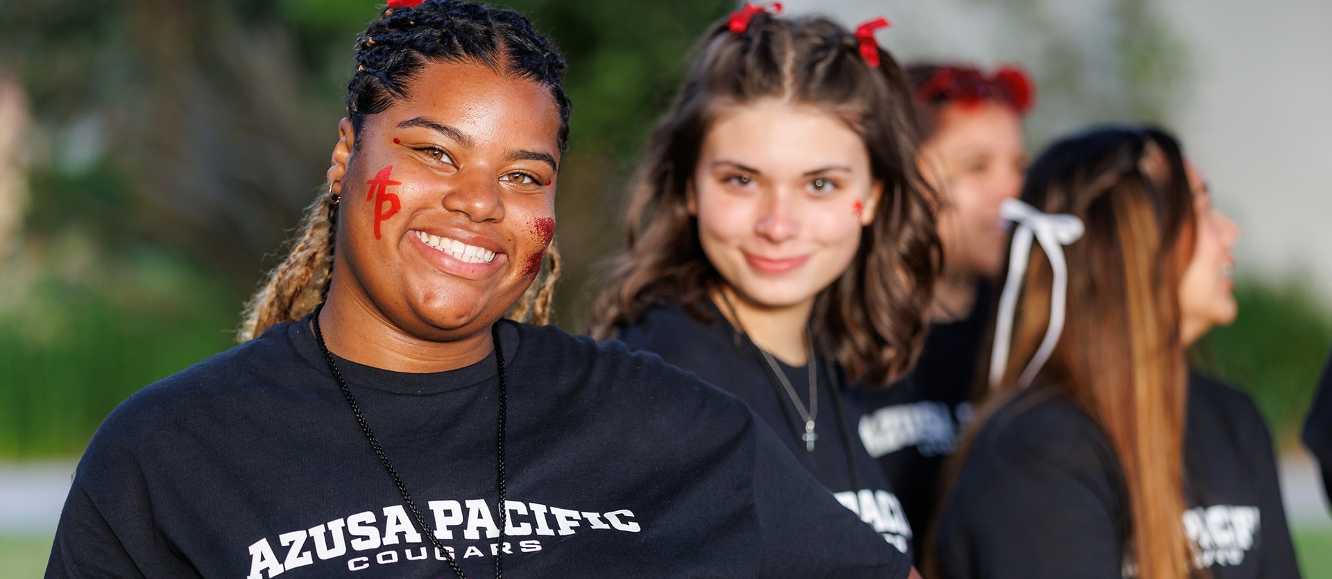 two APU students smiling at camera
